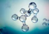 Aptar Advances Pharmaceutical Packaging as N-Sorb Technology Gains Patent Approval Molecular model with connected glassy spheres representing atoms and bonds, against a soft blue gradient background