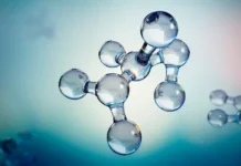 Aptar Advances Pharmaceutical Packaging as N-Sorb Technology Gains Patent Approval Molecular model with connected glassy spheres representing atoms and bonds, against a soft blue gradient background